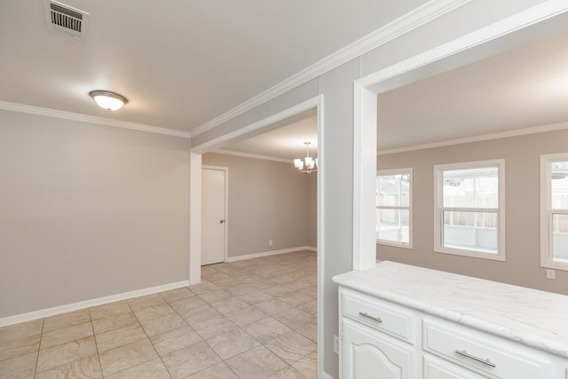 empty room featuring an inviting chandelier, crown molding, baseboards, and visible vents