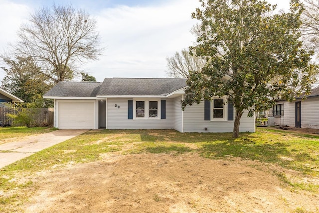 view of front of house with an attached garage, concrete driveway, a front yard, and fence