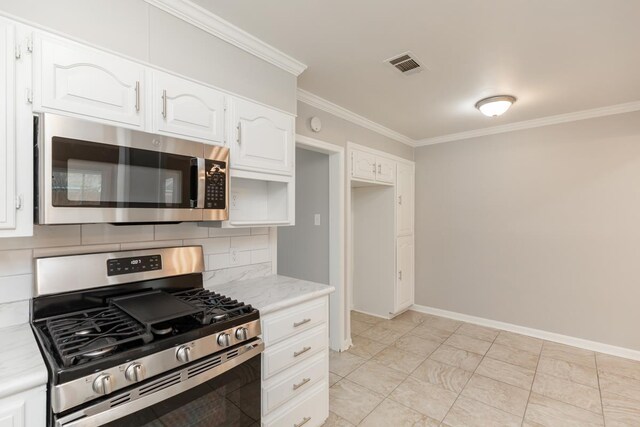 kitchen featuring visible vents, ornamental molding, decorative backsplash, stainless steel appliances, and white cabinetry