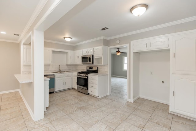 kitchen with tasteful backsplash, visible vents, appliances with stainless steel finishes, a peninsula, and white cabinets