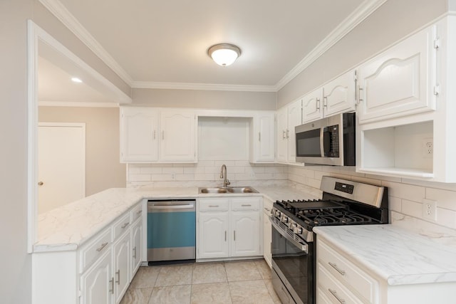 kitchen with a sink, stainless steel appliances, white cabinetry, crown molding, and backsplash