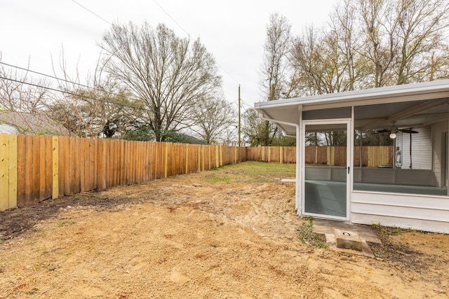 view of yard featuring a fenced backyard and a sunroom