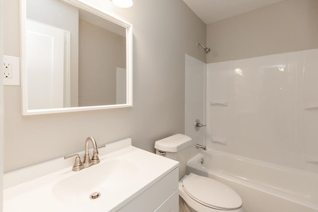 bathroom with toilet, vanity, and bathing tub / shower combination