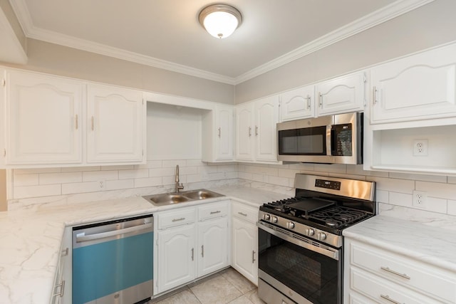 kitchen with backsplash, ornamental molding, white cabinets, stainless steel appliances, and a sink