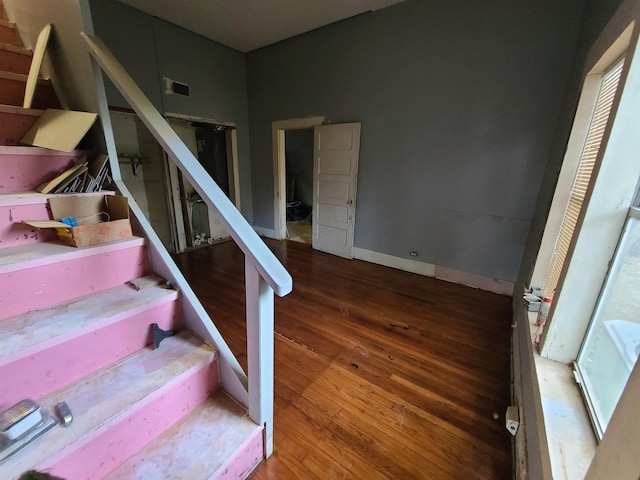 staircase with hardwood / wood-style flooring