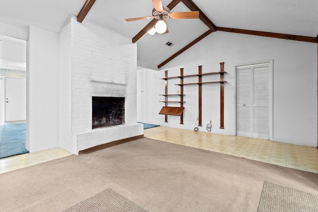 470 Junker Rd, Beaumont, TX 77707 - unfurnished living room featuring carpet flooring, ceiling fan, beamed ceiling, a fireplace, and high vaulted ceiling
