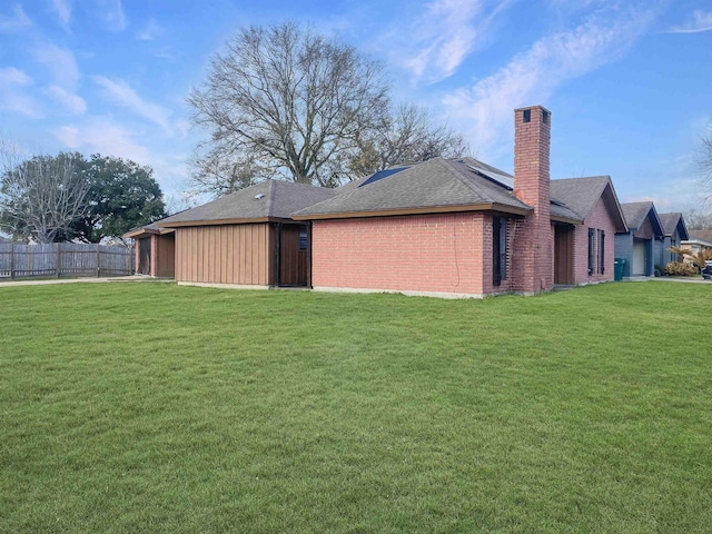 rear view of property featuring a lawn