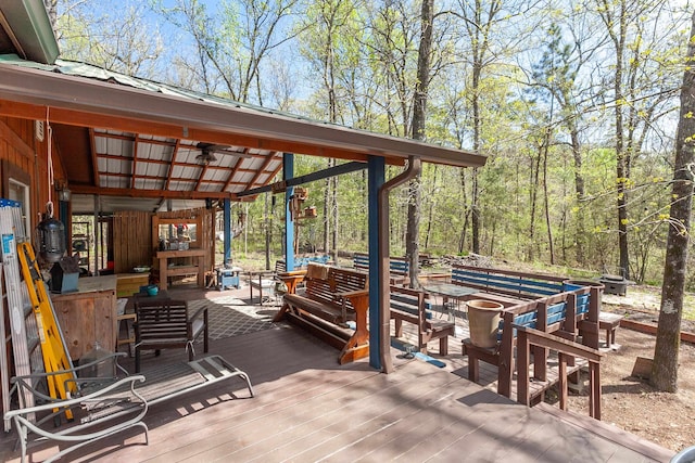 exterior space with ceiling fan and a deck