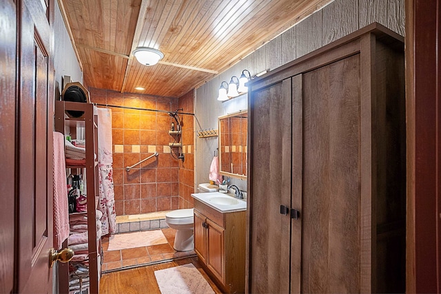 bathroom featuring walk in shower, toilet, vanity, and hardwood / wood-style flooring