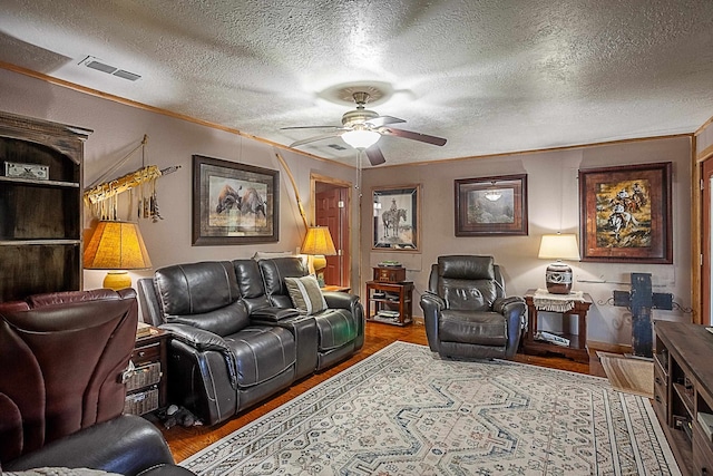 living room featuring crown molding, ceiling fan, a textured ceiling, and hardwood / wood-style flooring