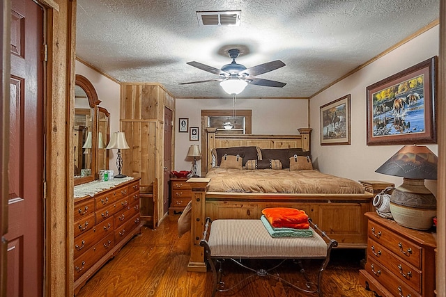 bedroom featuring a textured ceiling, dark hardwood / wood-style flooring, ceiling fan, and crown molding