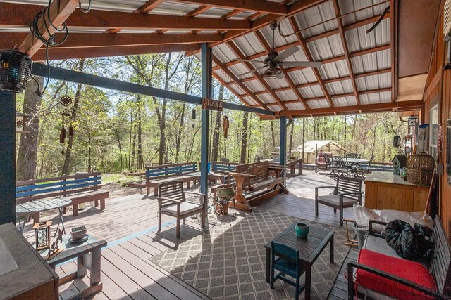 exterior space with outdoor lounge area, ceiling fan, and a wooden deck