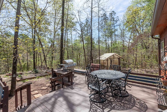 deck with grilling area and a shed