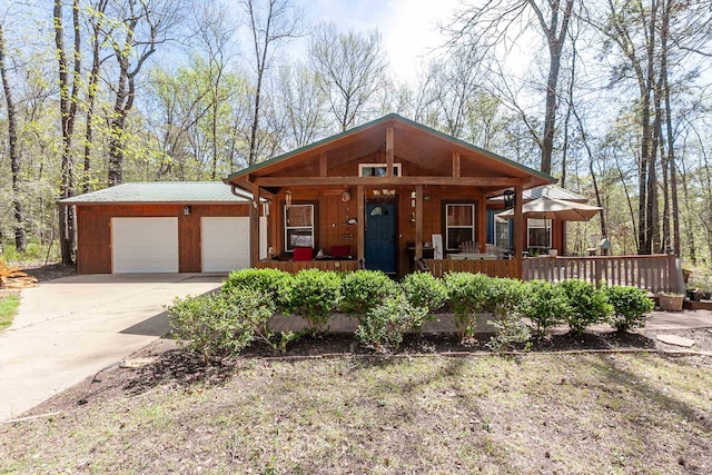 view of front of property featuring covered porch and a garage