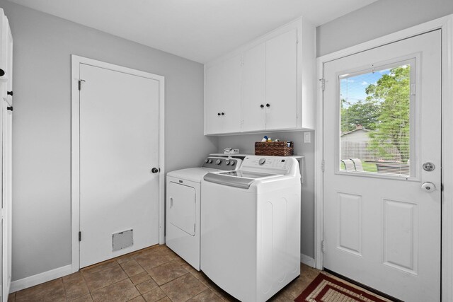 2040 Chevy Chase Ln, Beaumont, TX 77706 - laundry area with cabinet space, washing machine and clothes dryer, and baseboards