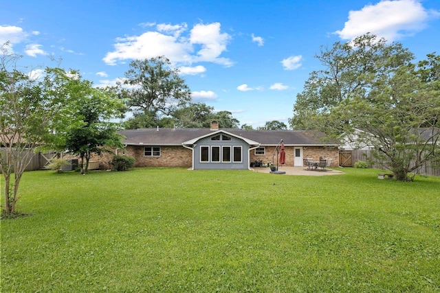 2040 Chevy Chase Ln, Beaumont, TX 77706 - rear view of house with a patio area, a chimney, and brick siding