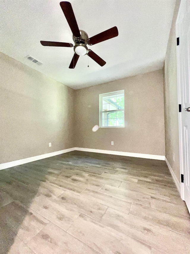 empty room with wood-type flooring and ceiling fan