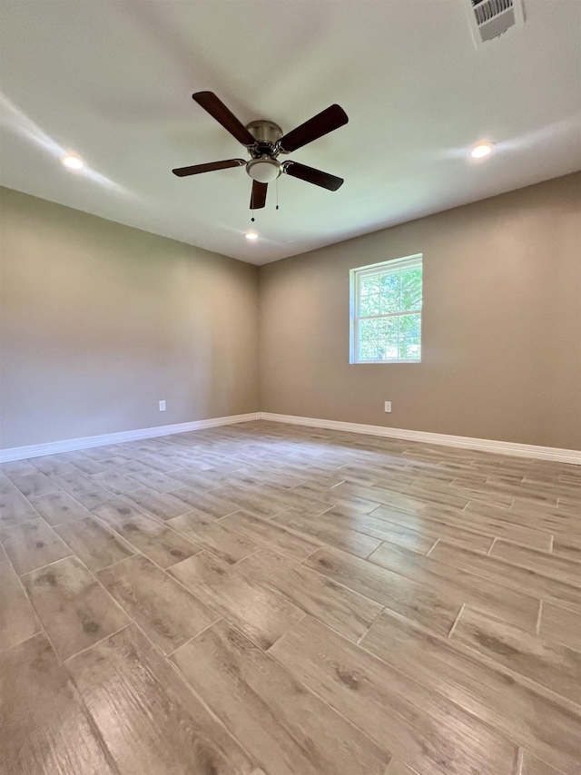 unfurnished room with ceiling fan and light hardwood / wood-style flooring