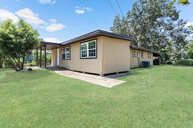 view of property exterior with a lawn and central air condition unit