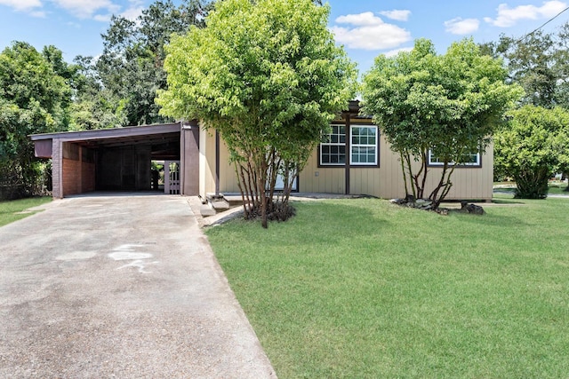 view of front facade with a front lawn and a carport