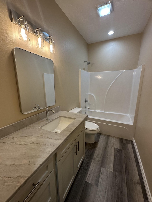 full bathroom with vanity, toilet, wood-type flooring, and shower / bath combination