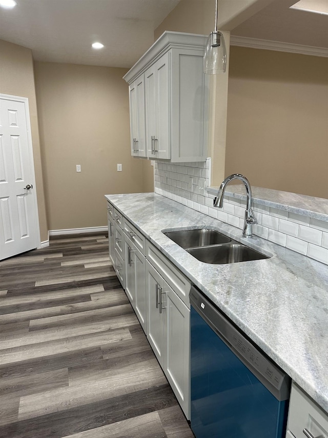 kitchen with dishwasher, backsplash, sink, ornamental molding, and white cabinetry