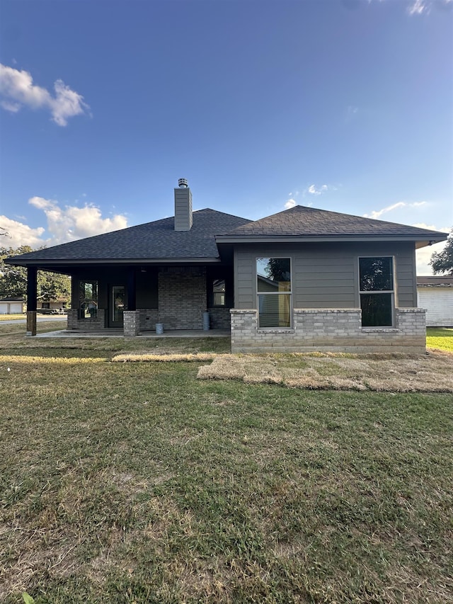 rear view of house with a lawn