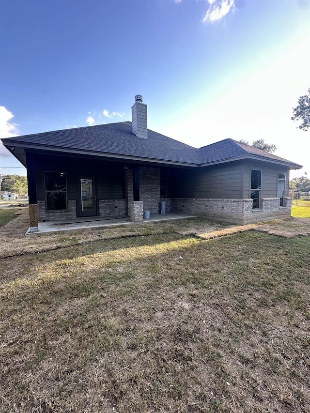 rear view of house with a lawn