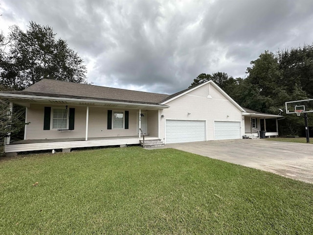 view of front of property with covered porch, a garage, and a front lawn