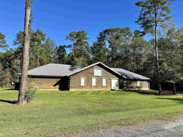 log cabin with a front lawn