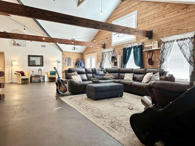 living room with high vaulted ceiling, beamed ceiling, a chandelier, concrete floors, and wood walls