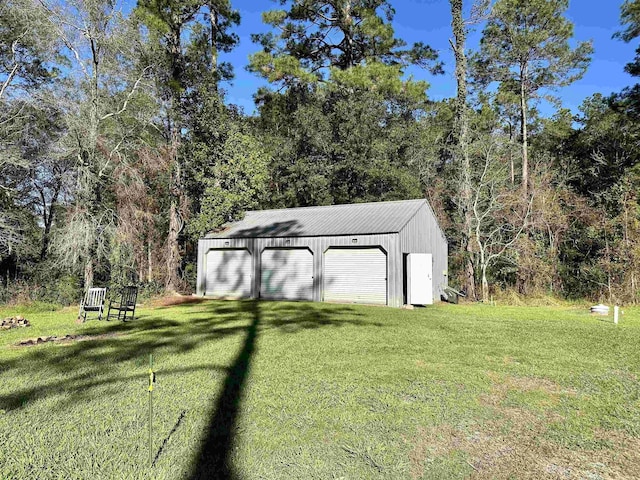 view of outdoor structure featuring a yard and a garage