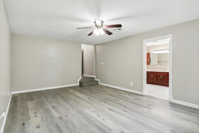 unfurnished room featuring ceiling fan and light wood-type flooring