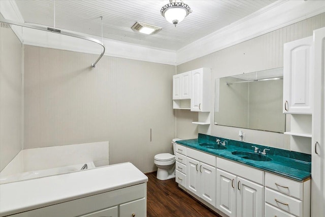 bathroom with crown molding, toilet, vanity, and hardwood / wood-style flooring