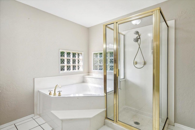 bathroom with separate shower and tub and tile patterned floors