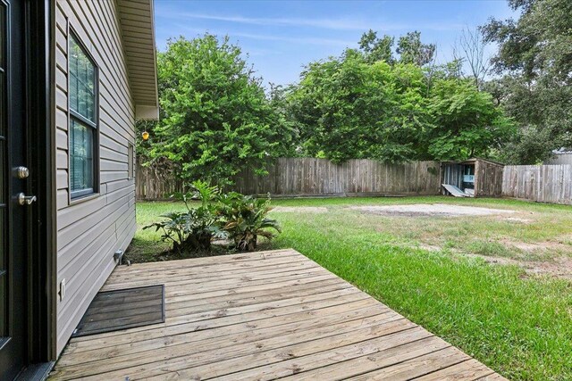 wooden deck with a lawn