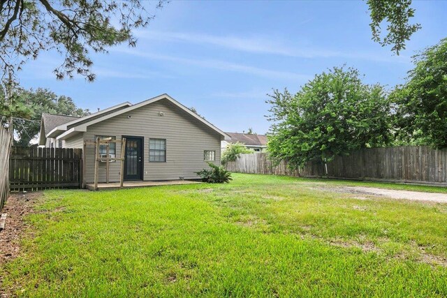 back of property featuring a yard