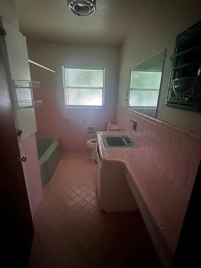 3848 Wentworth Ave, Port Arthur, TX 77642 - full bathroom with tile walls, vanity, tile patterned floors, and  shower combination