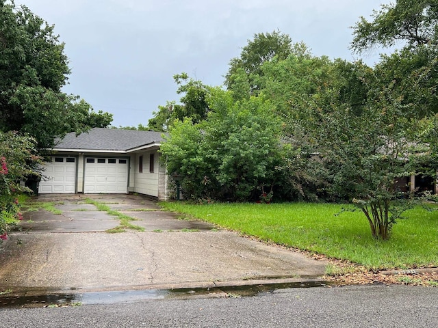 3848 Wentworth Ave, Port Arthur, TX 77642 - view of front of home with driveway, a front yard, roof with shingles, and an attached garage