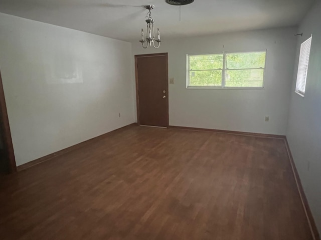 3848 Wentworth Ave, Port Arthur, TX 77642 - empty room with wood finished floors, plenty of natural light, and a chandelier
