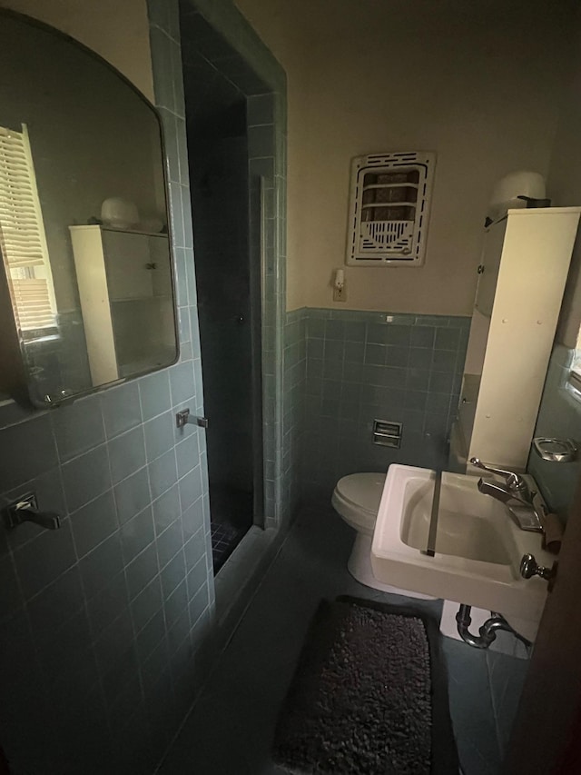 3848 Wentworth Ave, Port Arthur, TX 77642 - bathroom with tile walls, a stall shower, and a wainscoted wall