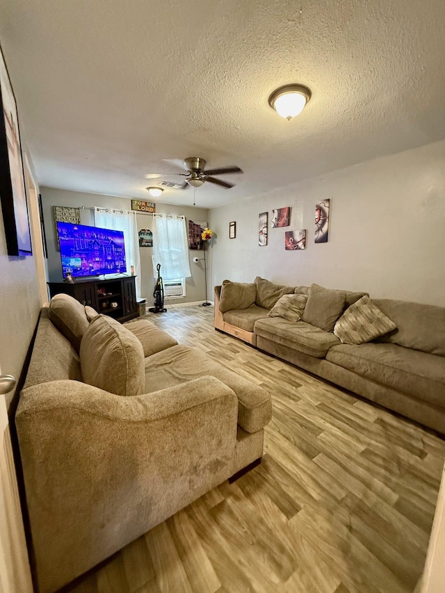 3656 Hemlock St, Orange, TX 77630 - living room featuring a textured ceiling, ceiling fan, and wood finished floors