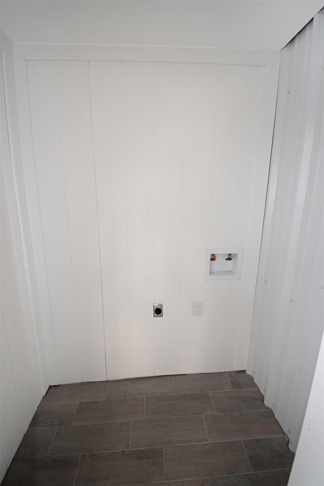 laundry room featuring hookup for an electric dryer, hookup for a washing machine, and wooden walls