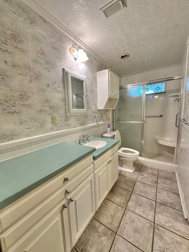 bathroom featuring tile patterned floors, walk in shower, a textured ceiling, vanity, and toilet