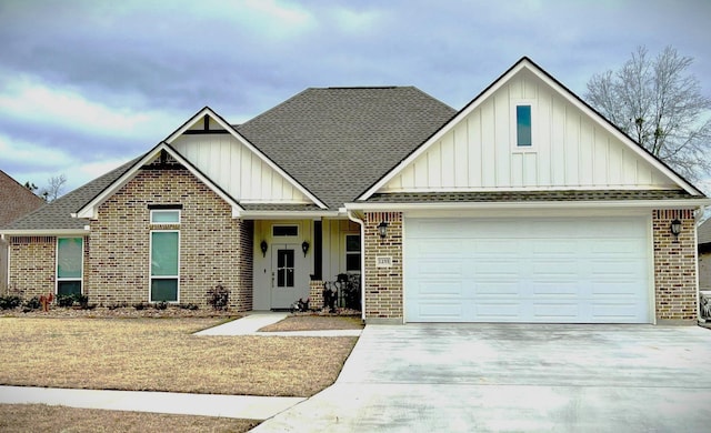 1255 Miss Kyndall, Lumberton, TX 77657 - view of front of house with board and batten siding, brick siding, concrete driveway, a garage, and roof with shingles