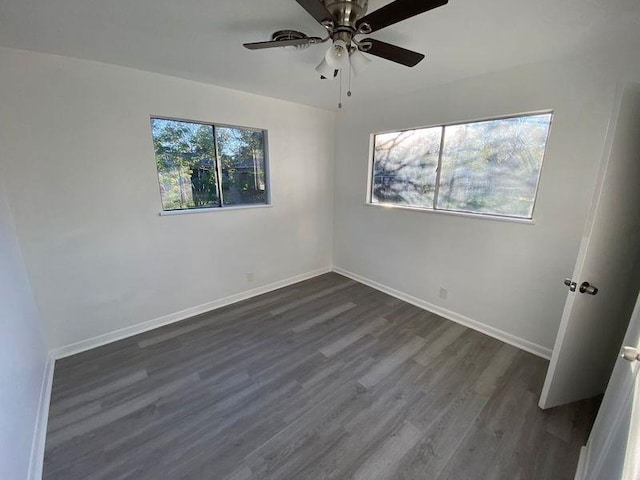 spare room with ceiling fan and dark wood-type flooring