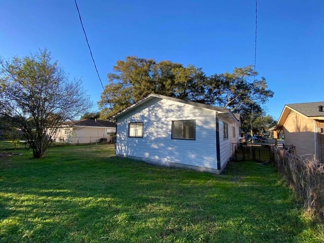 view of side of property with a lawn