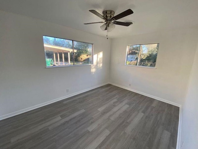 unfurnished room with dark hardwood / wood-style floors, ceiling fan, and a wealth of natural light