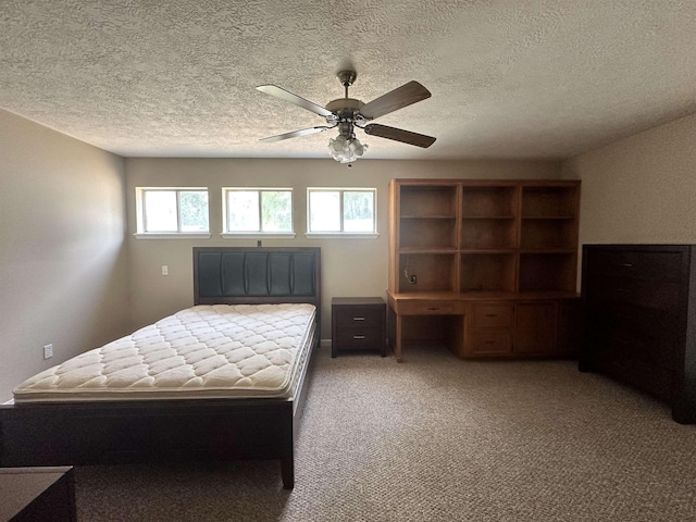 unfurnished bedroom with light carpet, a textured ceiling, and ceiling fan