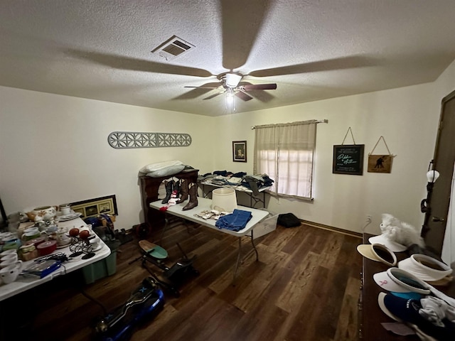 home office featuring a textured ceiling, ceiling fan, and dark hardwood / wood-style floors